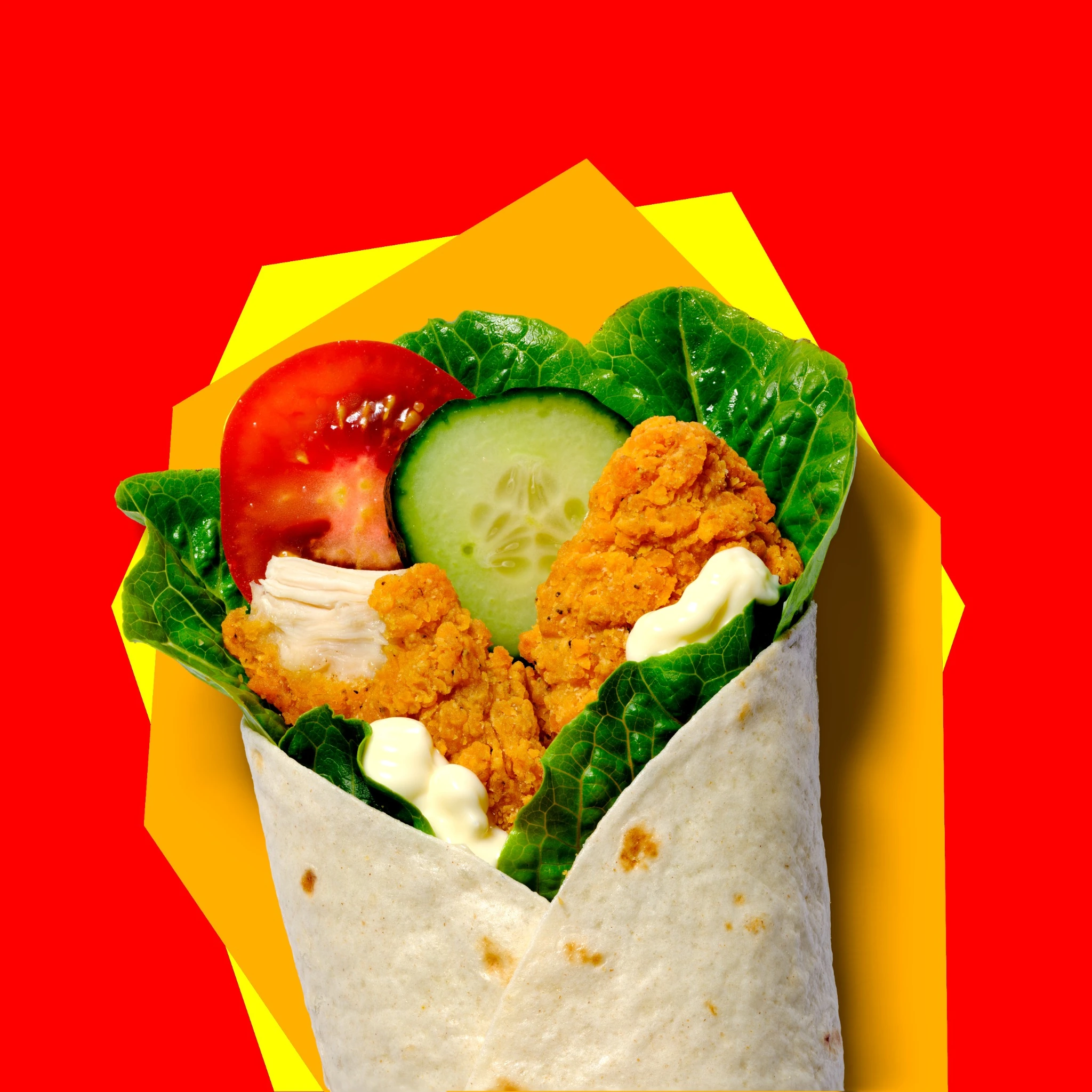 Crispy chicken wrap with lettuce, tomato and cucumber
